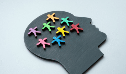 neurodiversity in the workplace - board of head silhouette with colourful wooden people