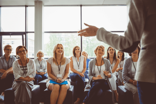 Sharing knowledge - employees listening to someone, looking engaged and happy