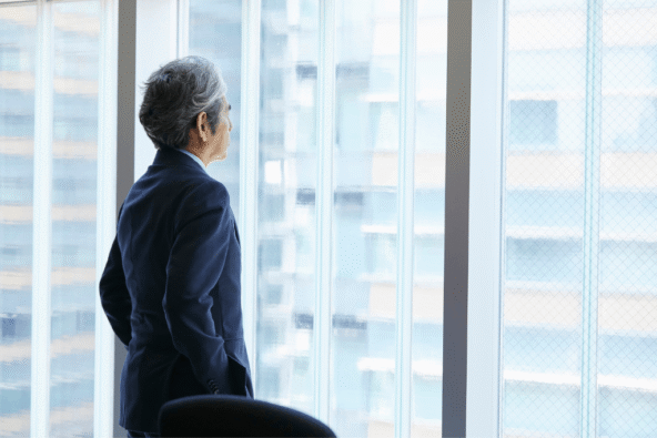 businessman looking lonely and sad looking out of window